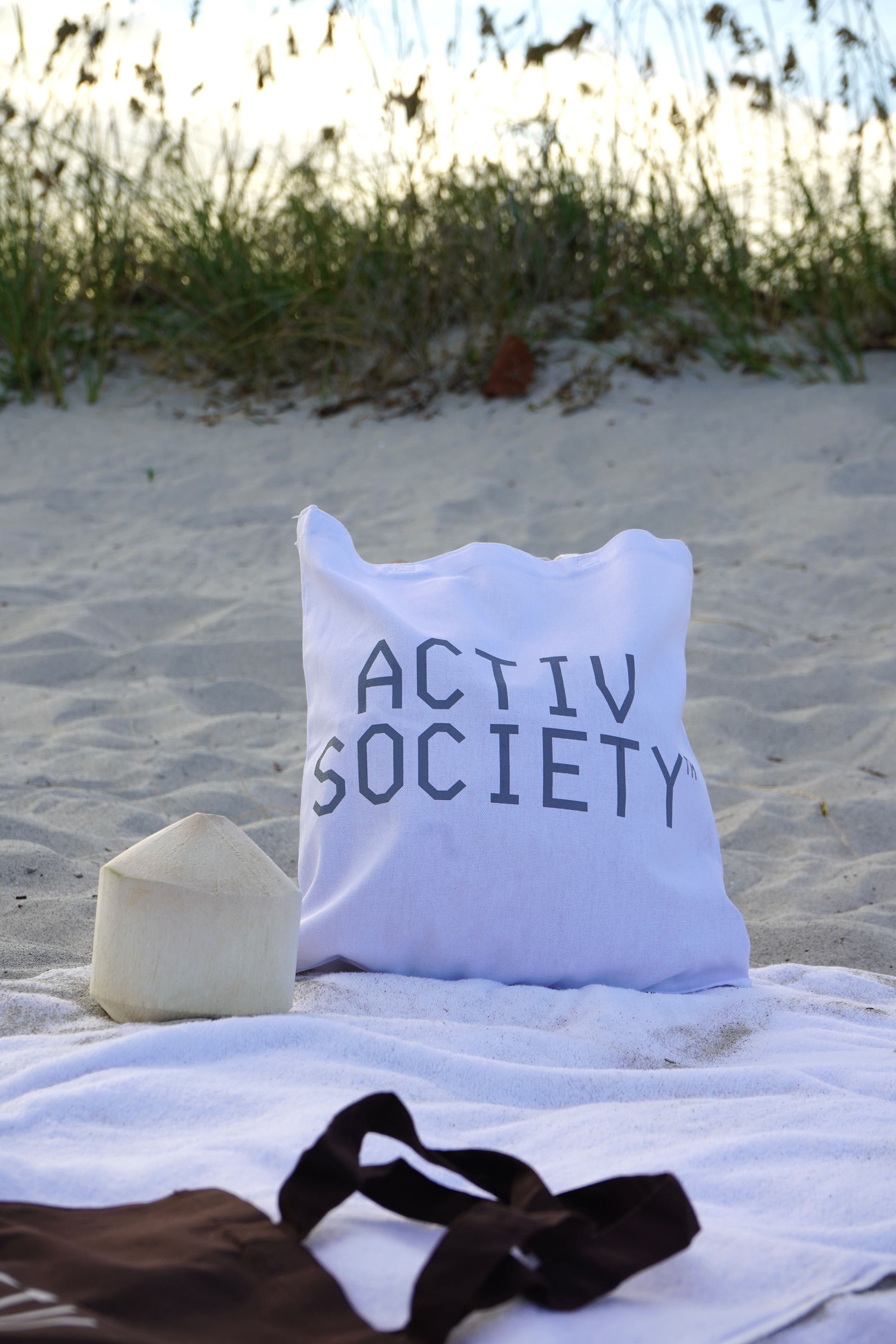 White Activ Society tote bag on beach